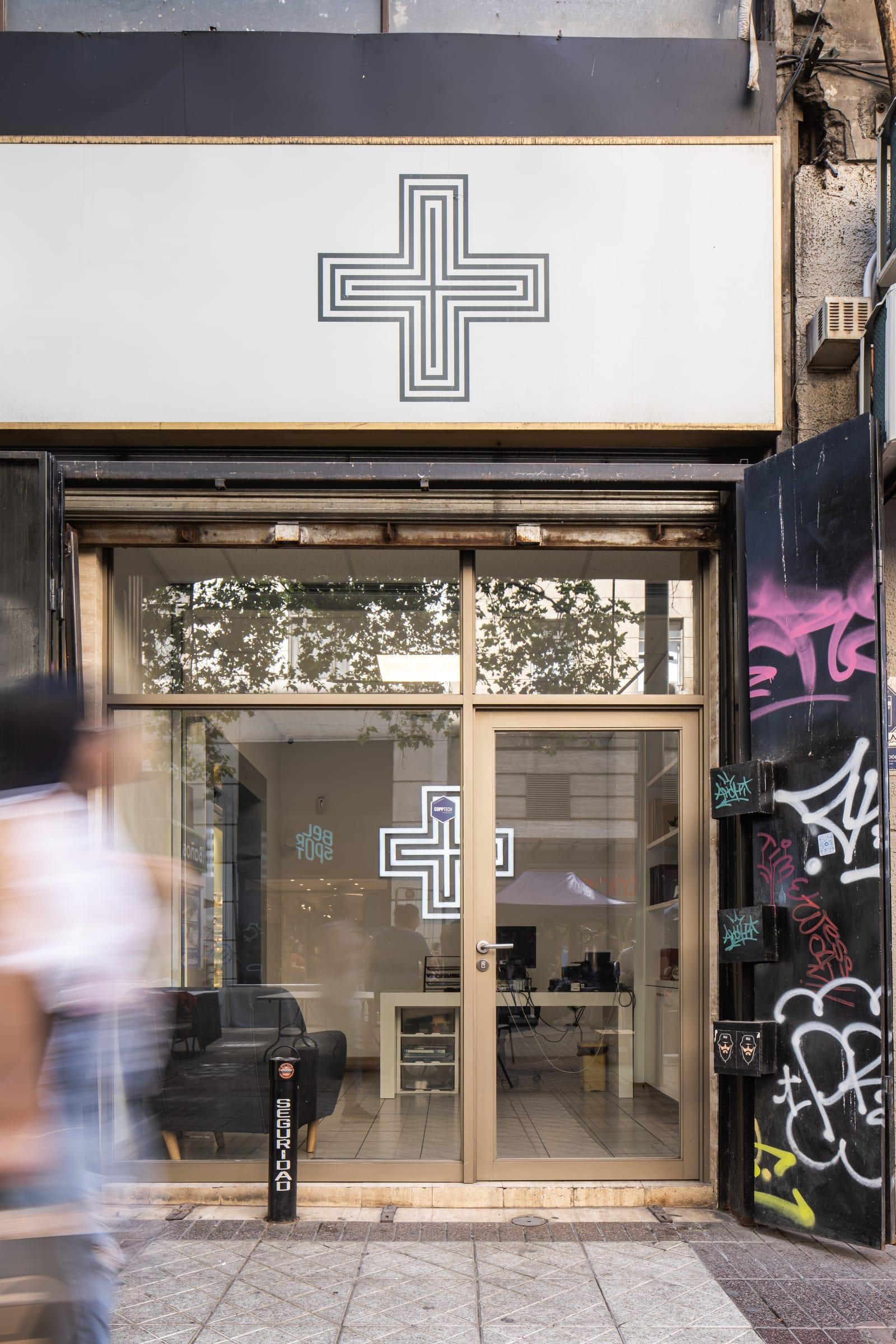 A storefront on a street with graffiti.